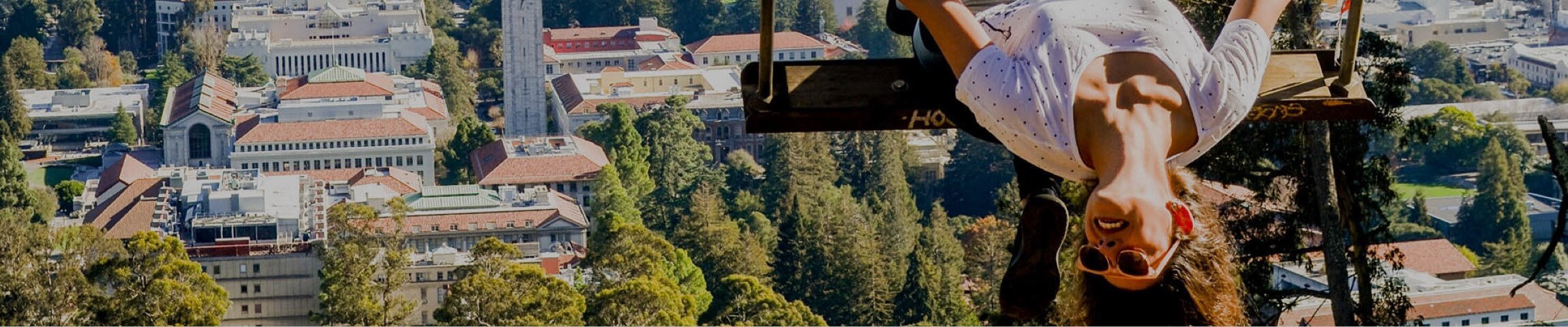 Photo of female student on a swing, in the hills high above the UC Berkeley campus