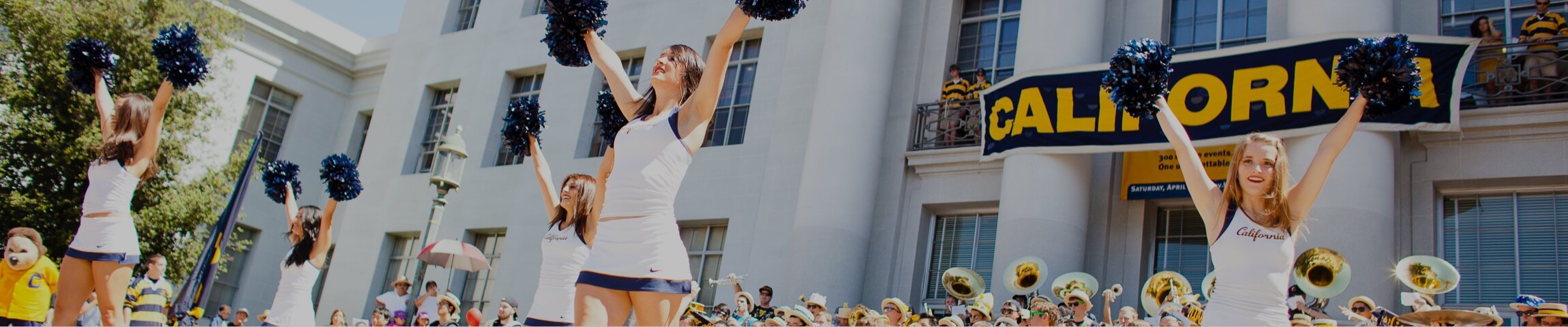 Photo of UC Berkeley cheerleaders with the Cal marching band