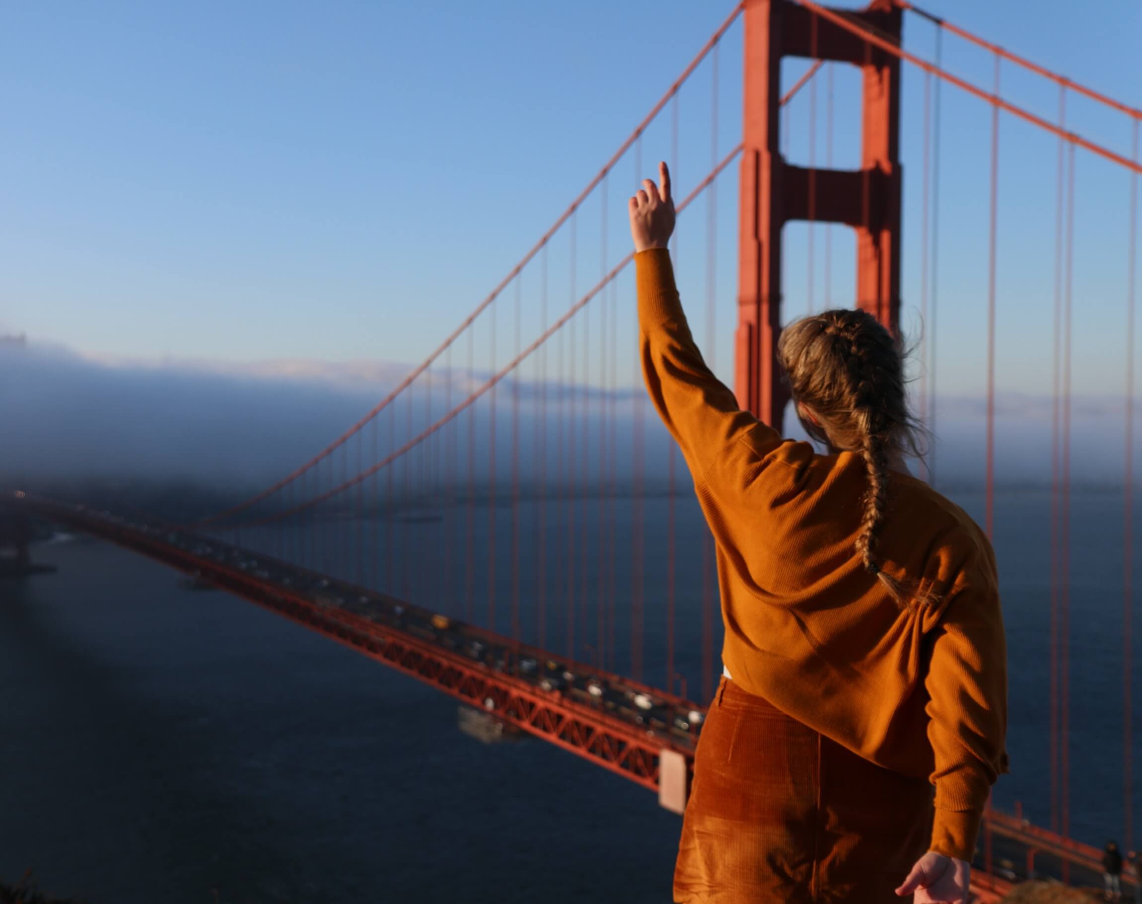 Photo of a woman and the Golden Gate Bridge