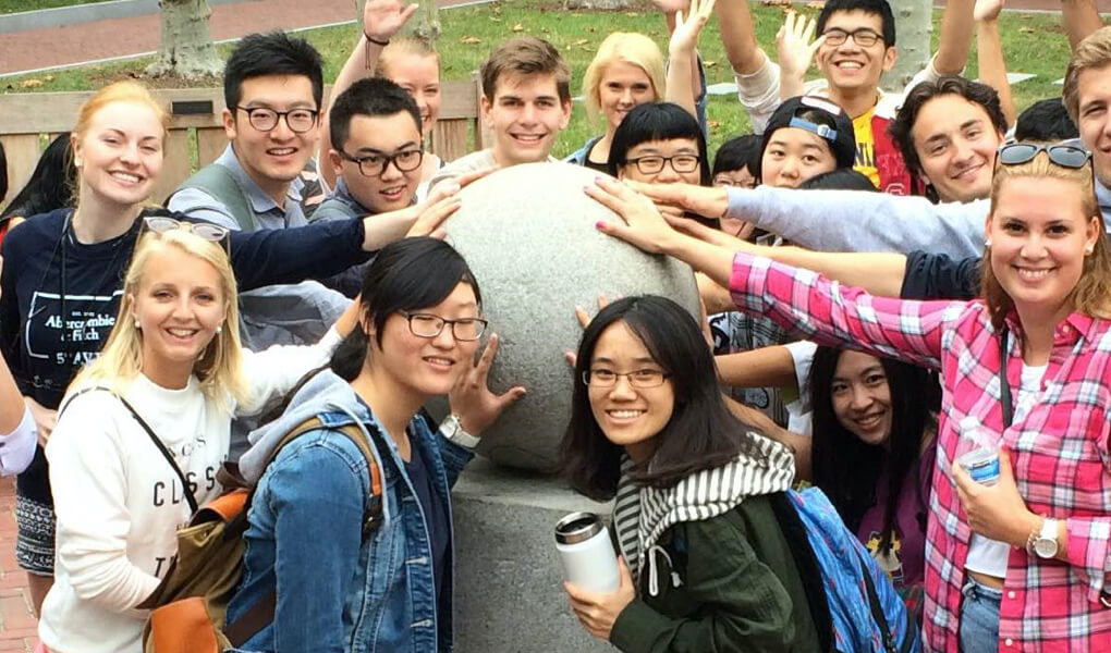 UC Berkeley students posing with the 4.0 Ball in front of the Campanile