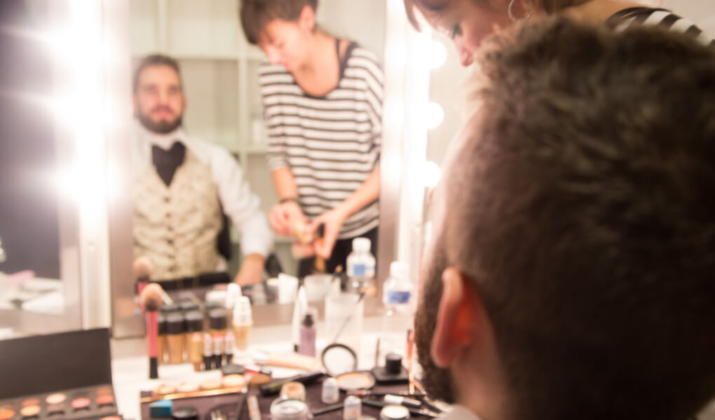 Photo of actors getting ready backstage for a performance