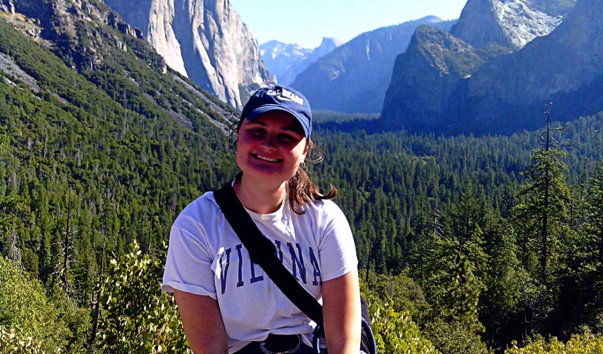 photo of Ingrid with a hat on and mountains in the background