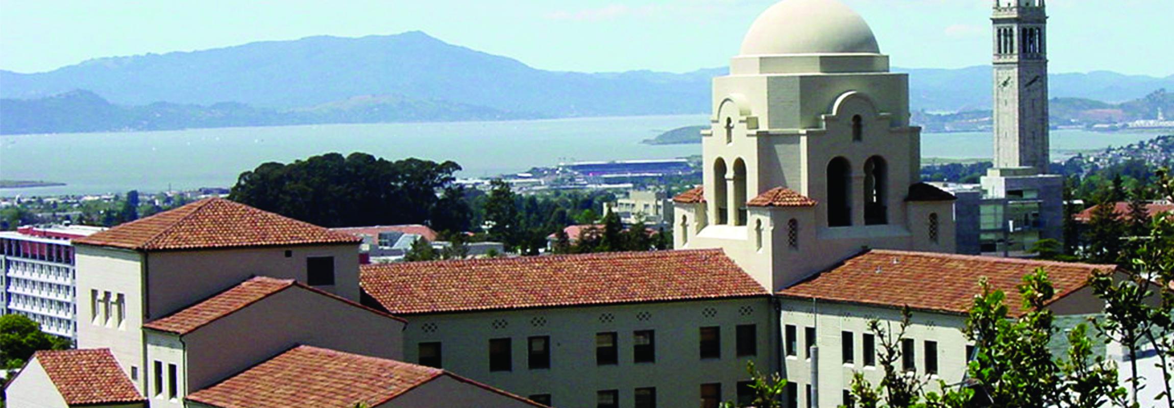 Photo of UC Berkeley buildings, with the Campanile and the bay in the background