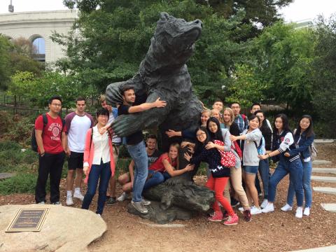Students hugging a bear statue on the UC Berkeley campus