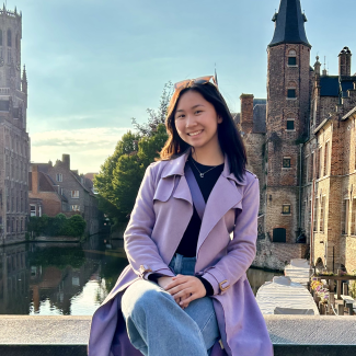 headshot of Claire Chiow with buildings and a river in the background